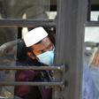 Men in facemasks wait on a bus taking them to a quarantine facility after they attended an Islamic gathering which has turned out to be a hotspot for Coronavirus infections in Nizamuddin, New Delhi