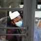 Men in facemasks wait on a bus taking them to a quarantine facility after they attended an Islamic gathering which has turned out to be a hotspot for Coronavirus infections in Nizamuddin, New Delhi