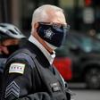 Coronavirus lockdown has hardly made a dent in the homicide rate in Chicago, where an officer is pictured monitoring a car caravan protest on May 7