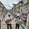 Humberto Montes (C) with musicians Roberto Maldonado (L) and Israel Mundo (R), wait to offer their services before a funeral at the municipal cemetery in Ciudad Nezahualcoyotl on June 3