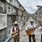 Humberto Montes (C) with musicians Roberto Maldonado (L) and Israel Mundo (R), wait to offer their services before a funeral at the municipal cemetery in Ciudad Nezahualcoyotl on June 3