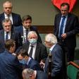 Leader of ruling Law and Justice (PiS) party Jaroslaw Kaczynski, wearing a mask, talks with ministers in parliament