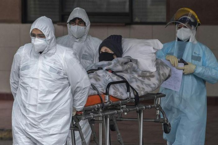 Infections have risen steadily in Chile though it began taking emergency measures in February; health staff transfer a patient with symptoms of COVID-19 at San Jose Hospital, in Santiago, on June 18, 2020