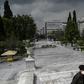 A man wearing a protective face mask walks at empty Athens' empty Syntagma square on March 23, 2020 as the country struggles to control the spread of the COVID-19, the novel coronavirus