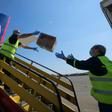 Police in Slovakia unload a plane after it touched down from China with testing kits and masks