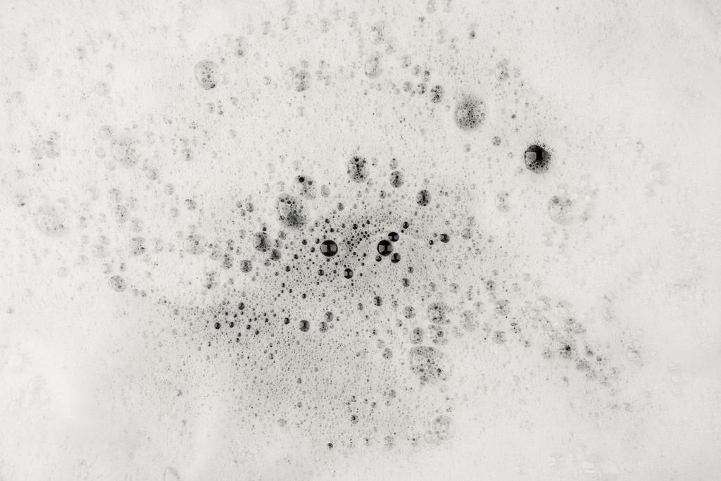 Foam bubble from soap or shampoo washing on top view texture background