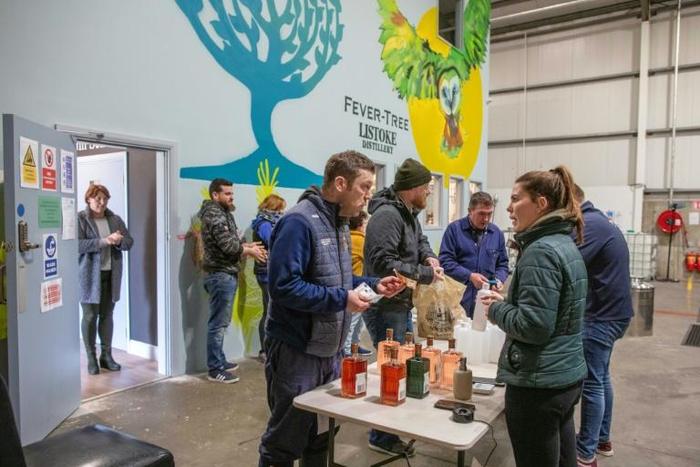 Customers queued out of the front door of the warehouse distillery and into the car park of the industrial estate outside, obeying strict "social distancing" measures