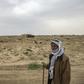 Farmer Hamad al-Ibrahim stands in his damaged fields in the eastern Syrian village of Baghouz