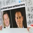 A demonstator holds up photos of detained Canadians Michael Spavor (left) and Michael Kovrig outside a May 2019 court appearance for Huawei chief financial officer Meng Wanzhou in Vancouver