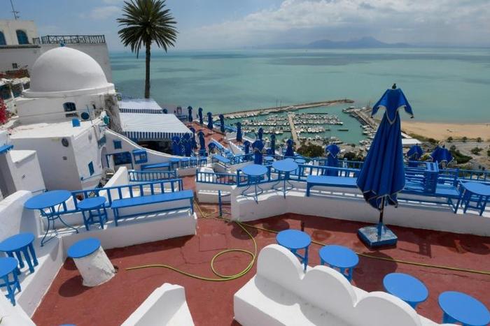 A cafe stands empty in the Tunisian village of Sidi Bou Said, where streets are usually filled with tourists at this time of year