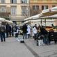 A municipal policeman checks people are keeping their distance at the fruit and vegetable market in piazza San Cosimato, in the Rome district district of Trastevere