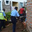 File image of police officers carrying a body. Police officer dies while having breakfast at girlfriend's house in Tena, Umoja Estate