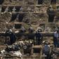 Workers dig graves in Santiago's General Cemetery after health authorities ordered them to prepare for a possible surge in deaths from COVID-19