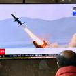 A man in a Seoul railway station watches a television broadcast on April 14, 2020, showing file footage of a North Korean missile test, after Pyongyang launched several suspected short-range cruise missiles toward the sea