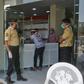 Mask-clad security guards and a patient at the entrance to al-Kubi hospital in Yemen's southern coastal city of Aden