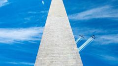 The US Navy Blue Angels (R) and US Air Force Thunderbirds fly past the Washington Monument on May 2, 2020, in a tribute to frontline workers during the coronavirus pandemic