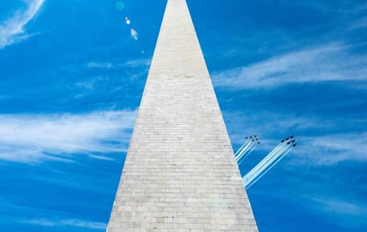 The US Navy Blue Angels (R) and US Air Force Thunderbirds fly past the Washington Monument on May 2, 2020, in a tribute to frontline workers during the coronavirus pandemic