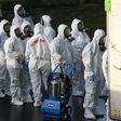 FILE PHOTO: Members of a Servpro cleanup crew wearing hazardous material suits prepare to enter Life Care Center of Kirkland, the Seattle-area nursing home at the epicenter of one of the biggest coronavirus outbreaks in the United States, in Kirkland, ...