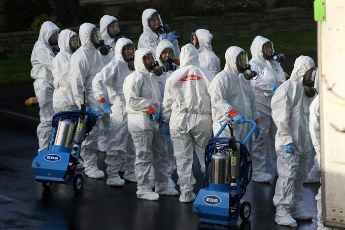 FILE PHOTO: Members of a Servpro cleanup crew wearing hazardous material suits prepare to enter Life Care Center of Kirkland, the Seattle-area nursing home at the epicenter of one of the biggest coronavirus outbreaks in the United States, in Kirkland, ...