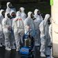 FILE PHOTO: Members of a Servpro cleanup crew wearing hazardous material suits prepare to enter Life Care Center of Kirkland, the Seattle-area nursing home at the epicenter of one of the biggest coronavirus outbreaks in the United States, in Kirkland, ...