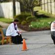 Father Scott Holmer is careful to keep a safe distance from his flock and asks parishioners to stay in their vehicles