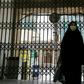 A woman walks past the closed gate of the Imamzadeh Saleh mosque in the Iranian capital Tehran on April 25. On Monday Iran reopened some places of worship in parts of the country deemed at low risk from the coronavirus