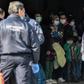 Migrants arrive at the port of Kavala on March 21, 2020, to be transferred to a closed camp in northern Greece as the country battles hard to control the novel coronavirus