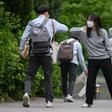 A staff member greeted students with an elbow bump as they returned to Kyungbock High School in Seoul after being closed for more than two-months because of coronavirus