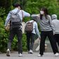 A staff member greeted students with an elbow bump as they returned to Kyungbock High School in Seoul after being closed for more than two-months because of coronavirus