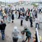 Shoppers stand in a queue as they wait to enter the Jabulani Mall in Soweto