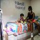 A Medellin sex worker and her young daughter sort through a food package donation