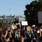 Demonstrators holding signs protest outside the White House over the death of George Floyd