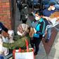 Food and packages of donated goods are distributed to people at a food bank in Chelsea, Massachusetts