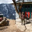 Security personnel stand guard during a nationwide lockdown in Namche Bazar in the Everest region. Thousands of tourists and trekkers are stranded in far-flung areas of Nepal