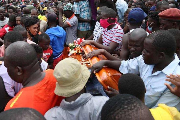 Mourner with Bernard Onyango aka Abenny Jachiga Coffin
