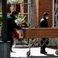 Mortuary employees wearing face masks wheel a coffin into the crematorium at  La Almudena cemetery in Madrid on Tuesday