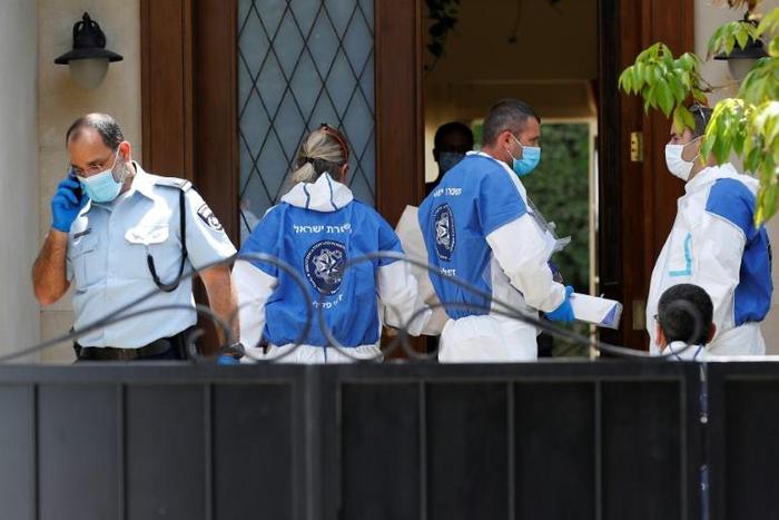 Police and forensic experts gather at the residence of the Chinese ambassador to Israel, Du Wei, on the outskirts of Tel Aviv after he was found dead on Sunday