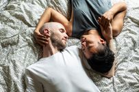 Directly above gay couple in bed