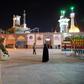 A cleric prays outside the Fatima Masumeh shrine in Iran's holy city of Qom on March 16, 2020, the day it was closed due to the coronavirus