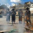Jewish men burn food with leavening agents ahead of the start of Passover, in the the ultra-Orthodox Mea Shearim neighbourhood of Jerusalem