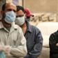 Egyptian men wait outside a food bank, after movement restrictions imposed to fight coronavirus crippled already precarious livelihoods