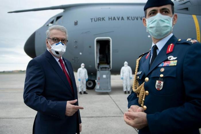 Turkey's ambassador to the United States, Serdar Kilic, waits as a Turkish cargo plane carrying COVID-19 relief supplies is unloaded at Andrews Air Force Base near Washington in April 2020