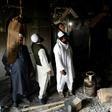 Muslim men check the interior of a partially burnt mosque on March 1, 2020 after communal riots in New Delhi