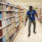 A man disinfects an empty supermarket in Dakar