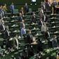 For the opening session of Iran's new parliament, a seat was left vacant between each lawmaker in accordance with social distancing guidelines although few wore masks against the coronavirus