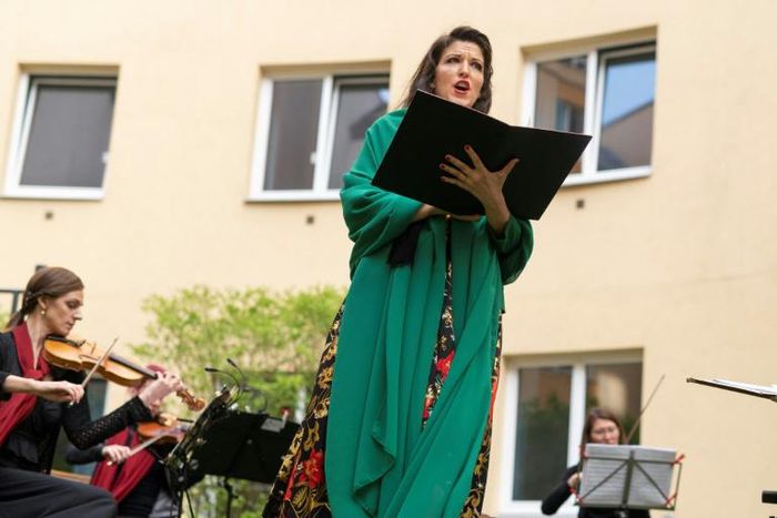 Monika Medek and the Camerata Carnuntum orchestra perform for guests during the 'window concert' at the Vienna hotel