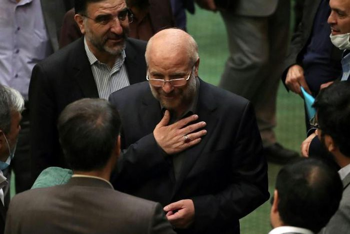 Iranian Mohammad-Bagher Ghalibaf (C) stands among members of parliament after being elected speaker