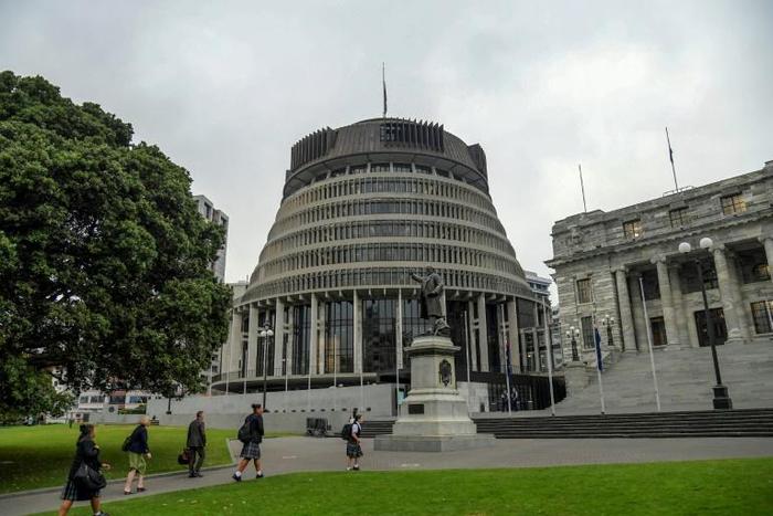 New Zealand's finance minister Grant Robertson has likened the government's virus response to a defensive tackle from the country's famous All Blacks