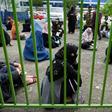 Afghan women keep their distance from each other while waiting for a bread handout in the capital, Kabul
