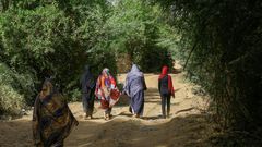 Sudanese women walk in the capital Khartoum's district of Jureif Ghar